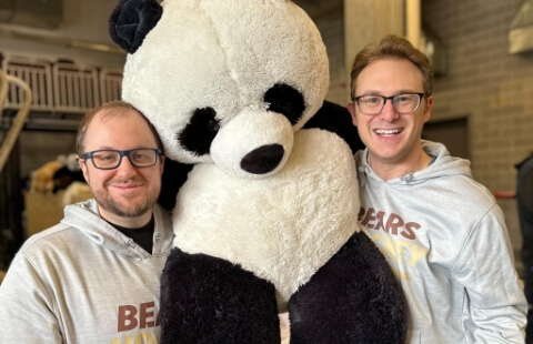 Hershey Bears players holding large stuffed panda