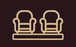 stylized logo of two luxury chairs advertising club lounge experience