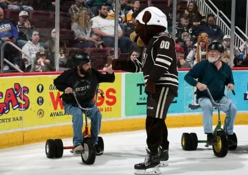 Fans participating in an interactive on ice promotion during an intermission.