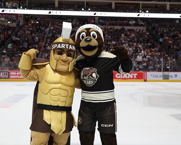 The Milton Hershey School Spartan mascot and Coco the Bear.