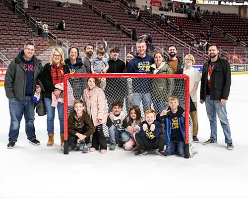 Family gathered on the ice for a post game photo.