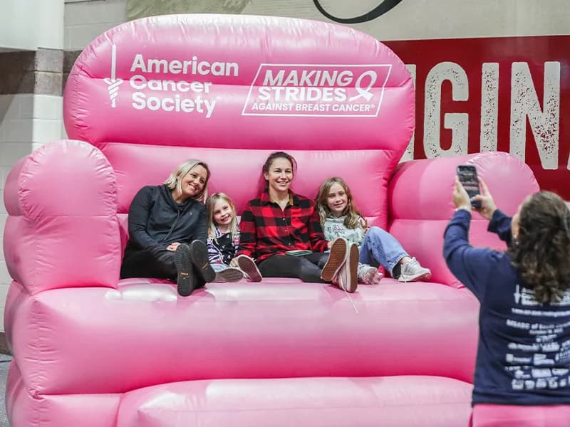 Fans seated on an inflatable pink chair at South End Fan Zone at GIANT Center.