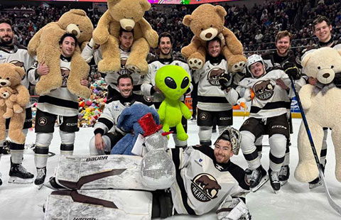Hershey Bears players with teddy bears and stuffed animals