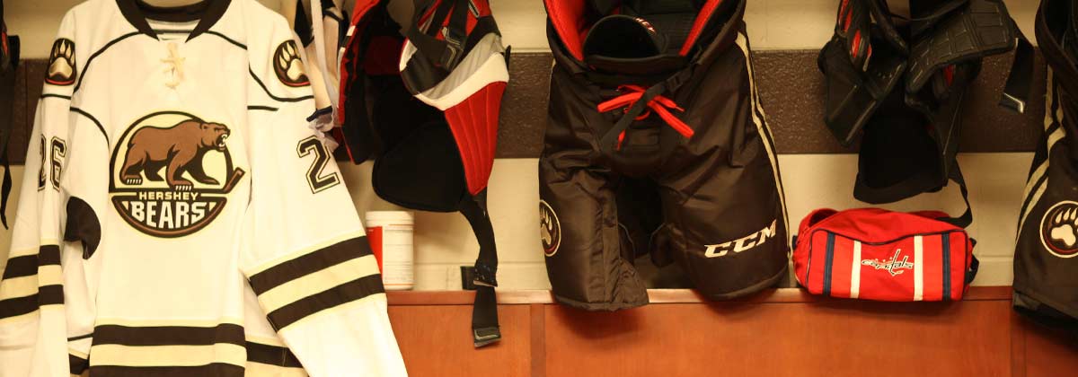 Bears jershey and equipment hangning in locker room