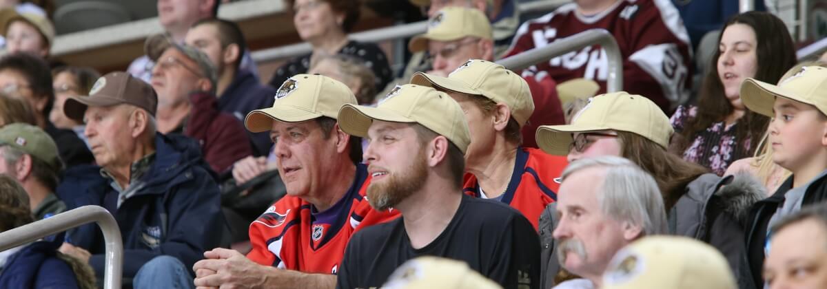 Hershey Bears fans watching hockey game in Hershey Bears hats