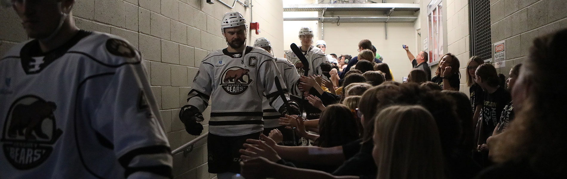 Fans high fiving players in tunnel