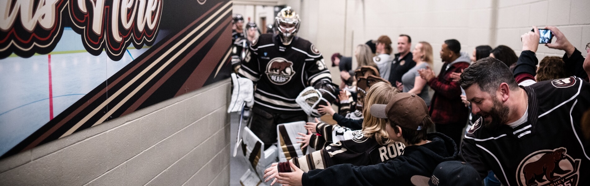 Fans high fiving players in tunnel