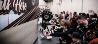 Fans watching Hershey Bears players in tunnel